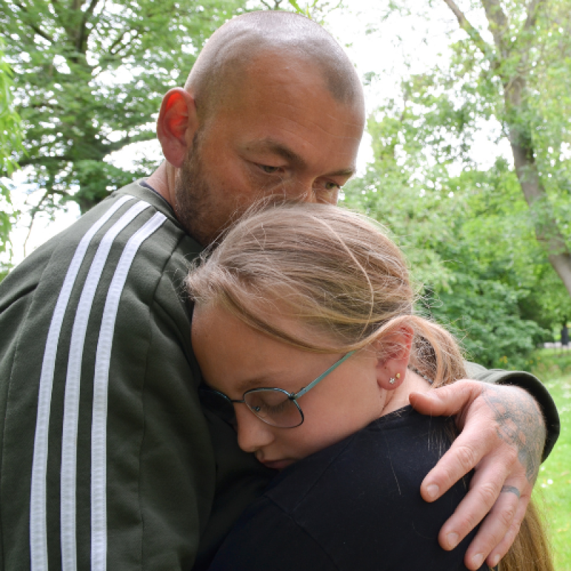 Parent comforts bereaved military child or young person
