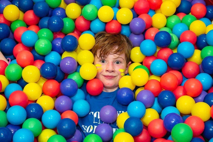 Sebastian in the ball pit at Scotty's Christmas party