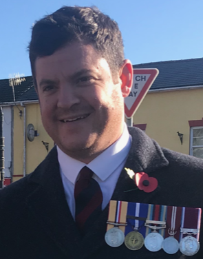 Gavin wearing his poppy and medals during Remembrance