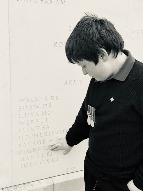 Jack touching his dad, Lee Rigby's, name on a stone memorial