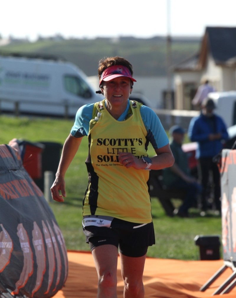 Paula running the Ultra Moray in her yellow and black Scotty vest