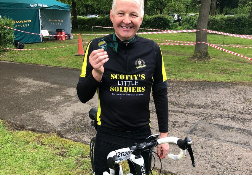 A Scotty supporter with his Tour de Scotty medal - proof he's beaten the challenge